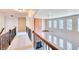 Upstairs hallway overlooking the living room featuring a fireplace and many windows for natural light at 3642 Lake Estates Way Way, Atlanta, GA 30349