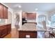 Large kitchen featuring granite countertops, a breakfast nook, hardwood floors, and an open view to the staircase at 3642 Lake Estates Way Way, Atlanta, GA 30349
