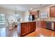 Well-lit kitchen area featuring granite countertops, an island, stainless steel appliances and hardwood flooring at 3642 Lake Estates Way Way, Atlanta, GA 30349