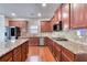 Spacious kitchen with granite countertops, stainless steel appliances, and dark wood cabinets at 3642 Lake Estates Way Way, Atlanta, GA 30349