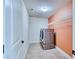 Well-lit laundry room with a modern washer and dryer, plus built-in shelving for storage at 3642 Lake Estates Way Way, Atlanta, GA 30349