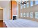 Open living room with large windows, fireplace, ceiling fan and high ceilings that create a bright and airy space at 3642 Lake Estates Way Way, Atlanta, GA 30349