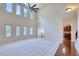 Spacious living room featuring large windows, a fireplace, a ceiling fan and an open concept design for easy entertaining at 3642 Lake Estates Way Way, Atlanta, GA 30349