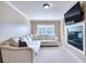 Inviting living room with comfortable seating, a fireplace, mounted television, and ample natural light from the window at 3642 Lake Estates Way Way, Atlanta, GA 30349