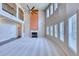 Bright and spacious living room with a fireplace, large windows, high ceilings, and a ceiling fan at 3642 Lake Estates Way Way, Atlanta, GA 30349