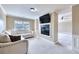 Comfortable living room features a fireplace, mounted television, and an adjoining room beyond the decorative columns at 3642 Lake Estates Way Way, Atlanta, GA 30349