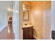 Elegant powder room features a dark wood vanity, decorative mirror, and a textured neutral-toned wall finish at 3642 Lake Estates Way Way, Atlanta, GA 30349