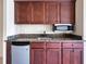 Close-up of the wet bar with granite countertop, mini fridge, and microwave at 3642 Lake Estates Way Way, Atlanta, GA 30349