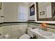 Charming bathroom featuring elegant wall tiles, decorative mirror, and classic fixtures at 3897 Tanbark Ct, Marietta, GA 30066