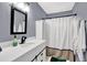 Bathroom featuring gray walls, a large mirror, and a shower with a curtain at 3897 Tanbark Ct, Marietta, GA 30066