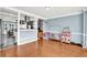 Open bonus room with hardwood floors, neutral wall paint, and views through to the modern kitchen at 3897 Tanbark Ct, Marietta, GA 30066