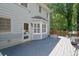 View of the home's backyard deck with a barbecue grill and a door into the house at 3897 Tanbark Ct, Marietta, GA 30066