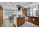 Bright kitchen featuring wood cabinets, stainless steel appliances, tile floor, central island, and granite countertops at 3897 Tanbark Ct, Marietta, GA 30066