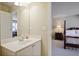 Bathroom featuring a single sink vanity and doorway leading into a bedroom at 414 Wallis Farm Way, Marietta, GA 30064