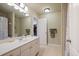 Bathroom featuring tiled floors, a shower-tub, a wide mirror, and double sink vanity at 414 Wallis Farm Way, Marietta, GA 30064