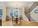 Cozy breakfast nook featuring a staircase, hardwood floors, and a charming chandelier at 414 Wallis Farm Way, Marietta, GA 30064
