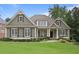 Charming home featuring classic design elements, manicured lawn, and lush landscaping at 414 Wallis Farm Way, Marietta, GA 30064