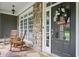 Inviting front porch with rocking chairs, stone accents, and a welcoming wreath on the front door at 414 Wallis Farm Way, Marietta, GA 30064