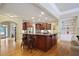 Beautiful kitchen featuring a large island with seating, stainless appliances, and built-in shelving at 414 Wallis Farm Way, Marietta, GA 30064