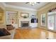 Inviting living room with stone fireplace, built-in shelving, and access to an outdoor space at 414 Wallis Farm Way, Marietta, GA 30064