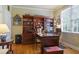 Cozy office with built-in shelves, a classic desk, and a comfortable workspace by the window at 414 Wallis Farm Way, Marietta, GA 30064