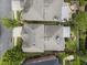 Aerial view of house roof and backyard showing patio with seating in a landscaped setting at 570 Society St, Alpharetta, GA 30022