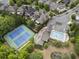 Overhead view of tennis courts and a community pool nestled within a residential area at 570 Society St, Alpharetta, GA 30022