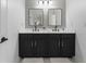 Modern bathroom featuring dual sinks, black hardware, and stylish mirrors at 570 Society St, Alpharetta, GA 30022