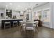 The dining area features a round table, seating for six, and is adjacent to the kitchen and living room at 570 Society St, Alpharetta, GA 30022