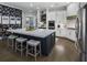 Modern kitchen featuring an island with seating, white cabinets, and stainless steel appliances at 570 Society St, Alpharetta, GA 30022