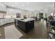 An open concept kitchen boasts a large island and blends seamlessly into the living area, perfect for entertaining at 570 Society St, Alpharetta, GA 30022