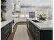 A modern kitchen with stainless steel appliances, including refrigerator, and large island features plenty of counter space at 570 Society St, Alpharetta, GA 30022