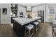 Kitchen features an island with seating, white cabinets, stainless steel appliances, and lots of storage at 570 Society St, Alpharetta, GA 30022