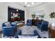 Elegant living room with blue chairs, hardwood floors, and plenty of natural light at 570 Society St, Alpharetta, GA 30022