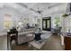 Open-concept living room with coffered ceilings, fireplace, and access to the outdoor space at 570 Society St, Alpharetta, GA 30022