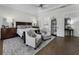 Serene main bedroom with a king-size bed, sitting area, and abundant natural light at 570 Society St, Alpharetta, GA 30022
