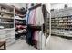 Spacious walk-in closet with custom shelving and ample storage for clothes, shoes, and accessories at 570 Society St, Alpharetta, GA 30022