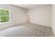 Bright bedroom featuring neutral carpet, a large window with a view, and fresh paint at 675 Crest Line Trl, Powder Springs, GA 30127