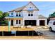 New two-story home under construction with visible framework and materials, showcasing the building process at 675 Crest Line Trl, Powder Springs, GA 30127