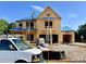 New construction home with visible framing, blue roofing and ladders on the exterior at 675 Crest Line Trl, Powder Springs, GA 30127
