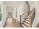 Inviting foyer with wood floors, a staircase, and ample natural light from the front windows at 675 Crest Line Trl, Powder Springs, GA 30127