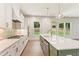 Modern kitchen featuring stainless steel appliances, quartz countertops, and a large island at 675 Crest Line Trl, Powder Springs, GA 30127