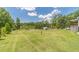 Vast, well-maintained backyard with lush lawn, white fence, and serene surroundings, ideal for leisure at 3040 Sandy Creek Ct, Loganville, GA 30052