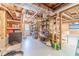 Unfinished basement with shelving, and painted concrete floor offers flexible storage and utility space at 3040 Sandy Creek Ct, Loganville, GA 30052