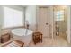 Luxurious bathroom featuring a standalone tub, elegant fixtures, and natural light, creating a peaceful retreat at 3040 Sandy Creek Ct, Loganville, GA 30052