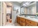 Bathroom featuring wood cabinets, a large mirror, and neutral wall color at 3040 Sandy Creek Ct, Loganville, GA 30052