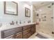 This modern bathroom features dual sinks, a walk-in shower, and sleek fixtures for a luxurious experience at 3040 Sandy Creek Ct, Loganville, GA 30052
