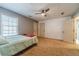 Neutral bedroom featuring a ceiling fan, natural light, and a minimalist design at 3040 Sandy Creek Ct, Loganville, GA 30052