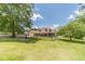 Beautiful exterior with a well-manicured lawn, a welcoming porch, complemented by lush trees at 3040 Sandy Creek Ct, Loganville, GA 30052