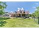 Charming home featuring a long porch, fenced yard, dormer windows, and lush green lawn and professional landscaping at 3040 Sandy Creek Ct, Loganville, GA 30052